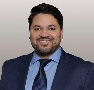 Ricardo Corporan a Latinx biracial cisgender gay man in a blue suit