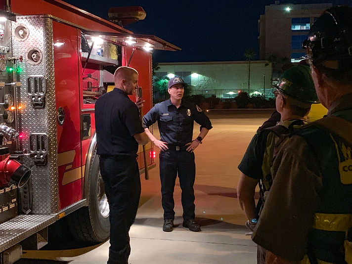 LA County firefighters exhibiting the equipment stored on a firetruck.