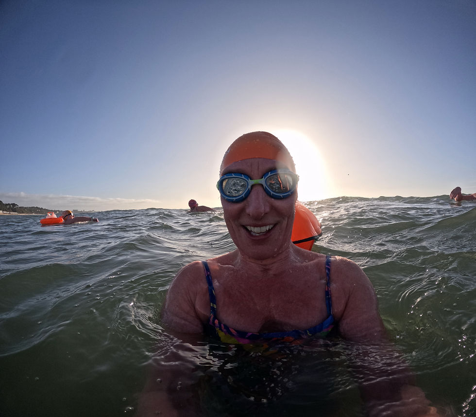Picture of swimming coach with swimmers in background