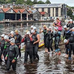 Swimmers entering the water for the Dart 10k
