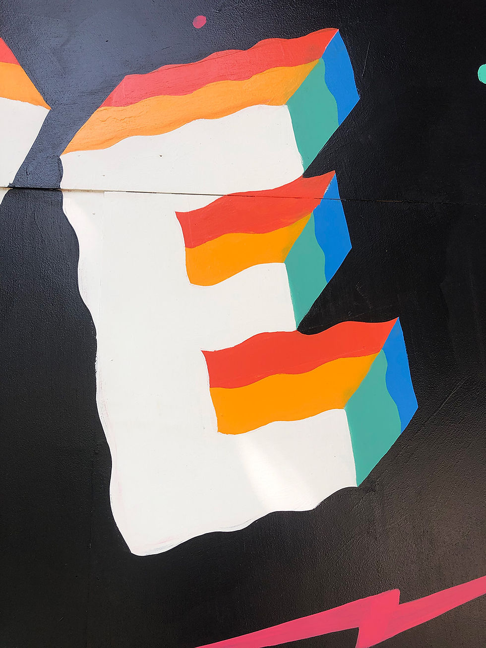 the letter E painted in psychedelic colors
