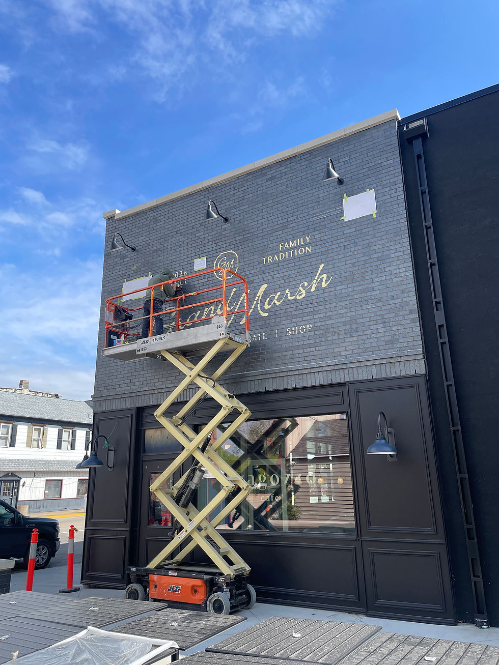 sign painter on a scissor lift
