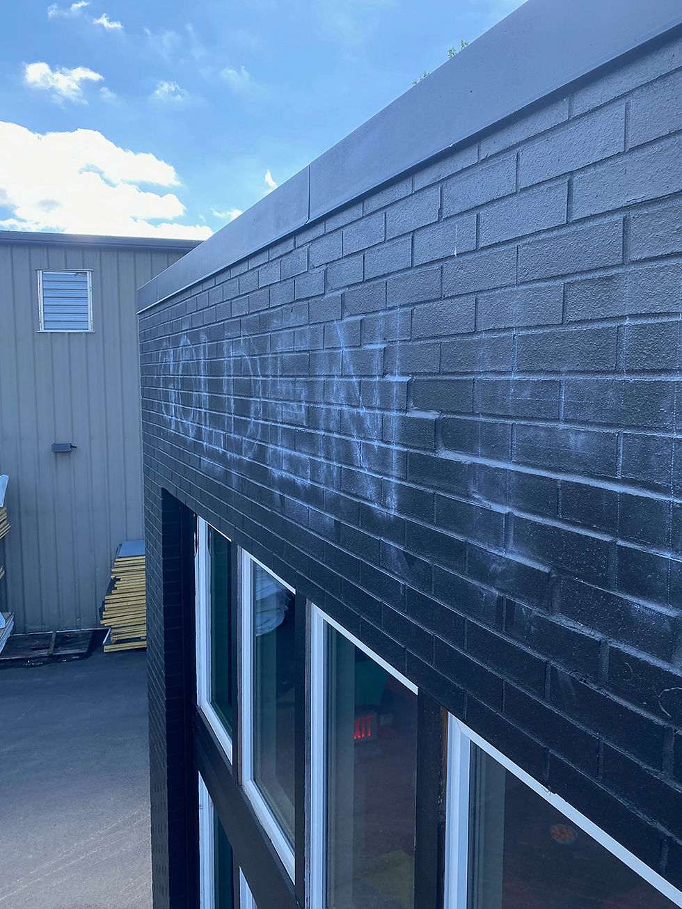 sign painting process on brick wall