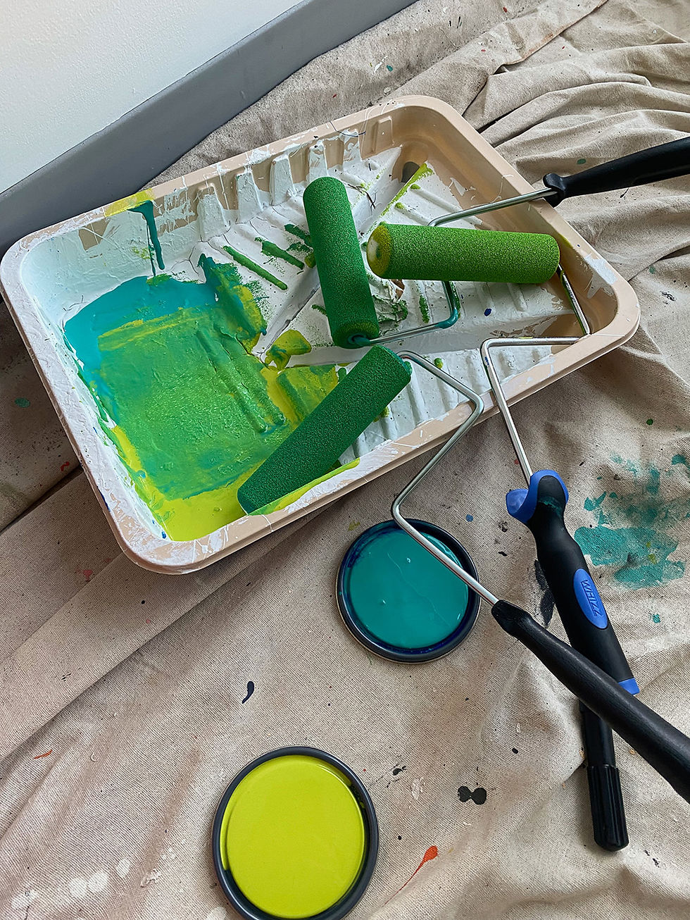 green and yellow paint getting blended fro mural