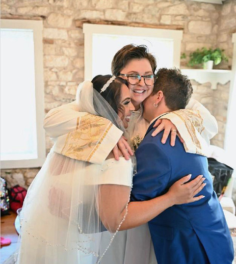 Melissa and Marion congrats hug from Rev. Benae