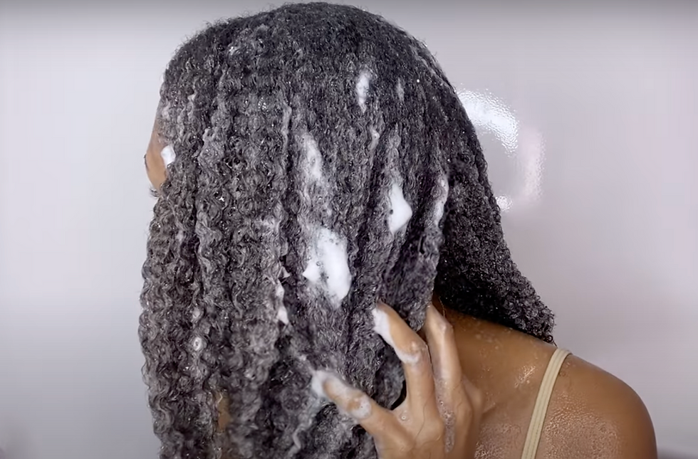 Girl washing her curly hair