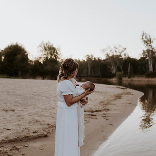 Mother and baby wearing whites and beiges for their outdoor shoot