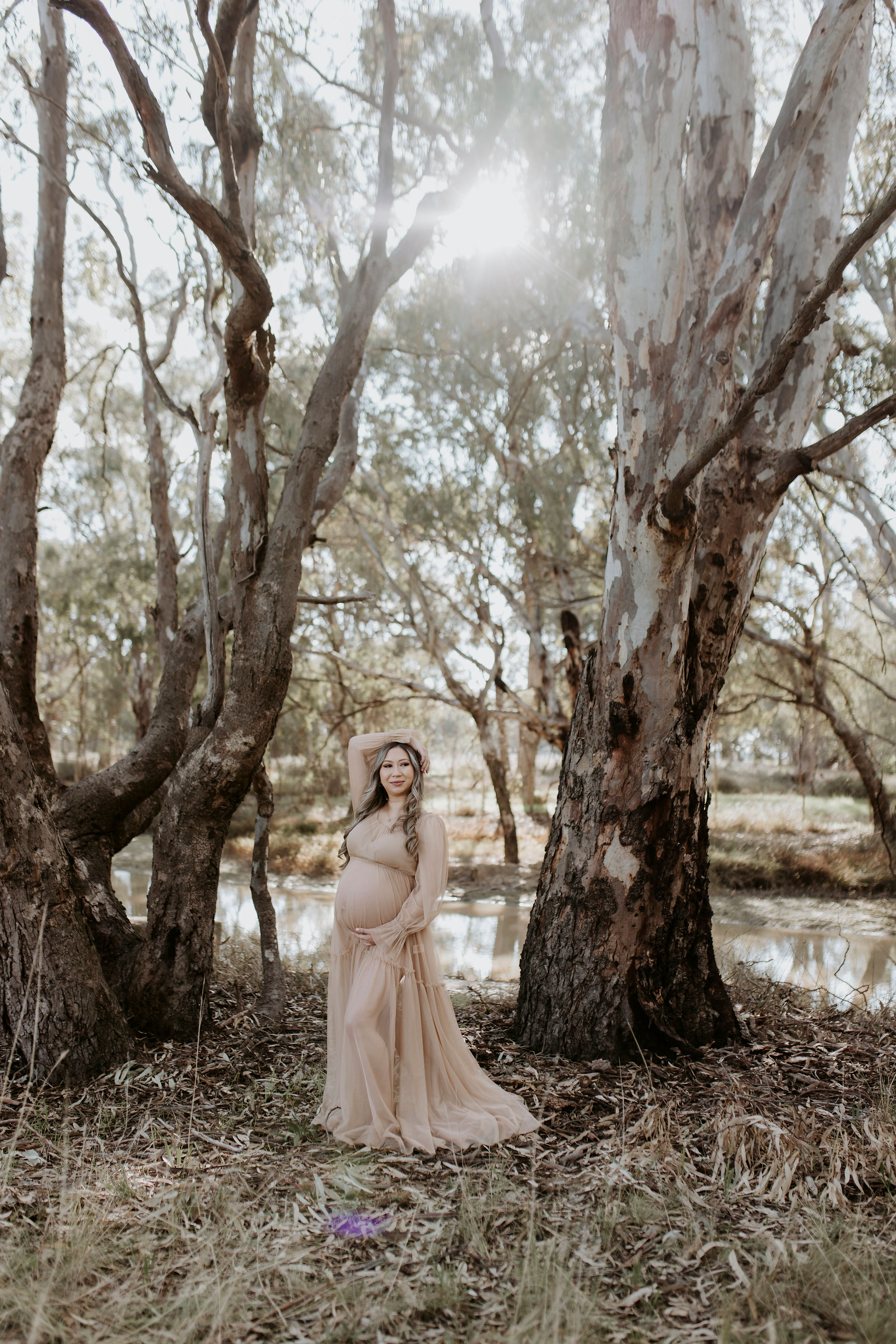 Mum wearing a brown flowy dress during her maternity shoot which compliments her body and bump
