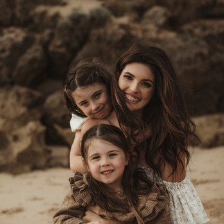 Family playing outdoors during golden hour, dressed in soft neutral tones – Nicole Peters Photography