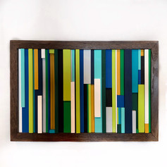 Art created from strips of wood with different widths and lengths painted with shades of green, blue, turquoise, yellow and white