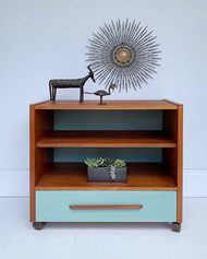 Small teak entertainment cabinet on casters. Glass doors removed and drawer front painted with Vintage Duck Egg by Wise Owl Paint