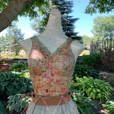 Vintage mannequin with glass mosaic bodice, close up view