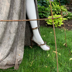 Vintage mannequin garden trellis. Close up view of steampunk style shoe