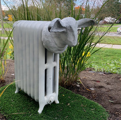 Garden sculpture made from cast iron radiator and concrete sheep head