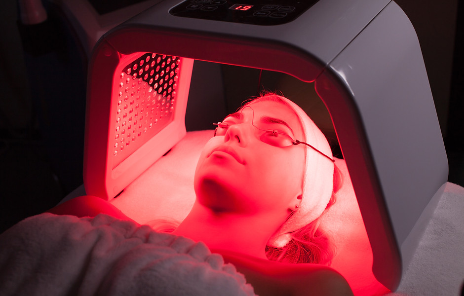 Young woman having LED light facial treatment in beauty salon.jpg