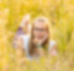 Abi laid in a wild flower meadow smiling