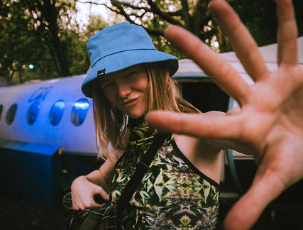 Festival-goers dancing under colorful lights at Lost Village Festival