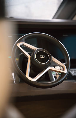Detail of Princess Yachts helm wheel showcasing logo and premium finish during event coverage