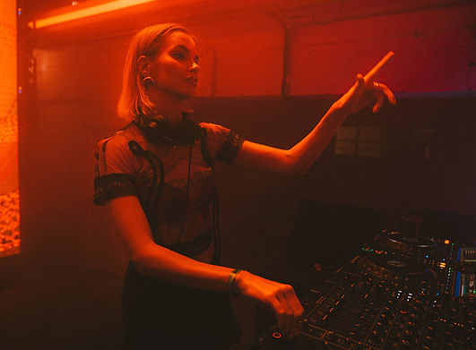 DJ performing on stage at Beonix Festival, with festival lights and crowd