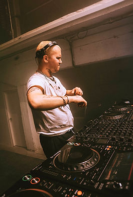 DJ performing on stage at Beonix Festival, with festival lights and crowd