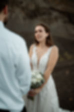 bride lovingly looks at groom during iceland wedding ceremony