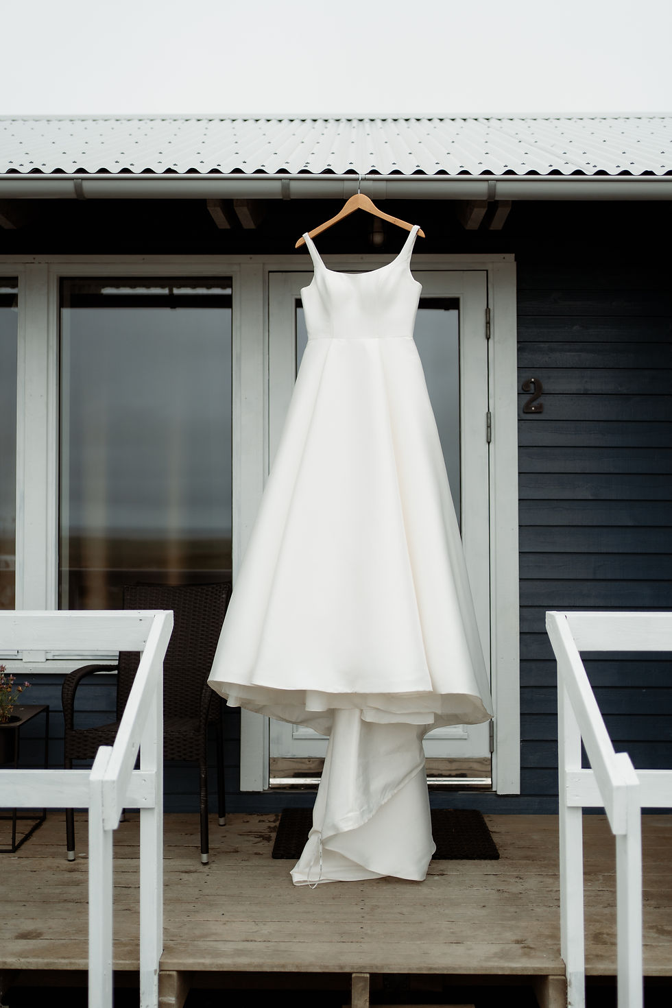 wedding dress photo hangs outside for an iceland wedding day.
