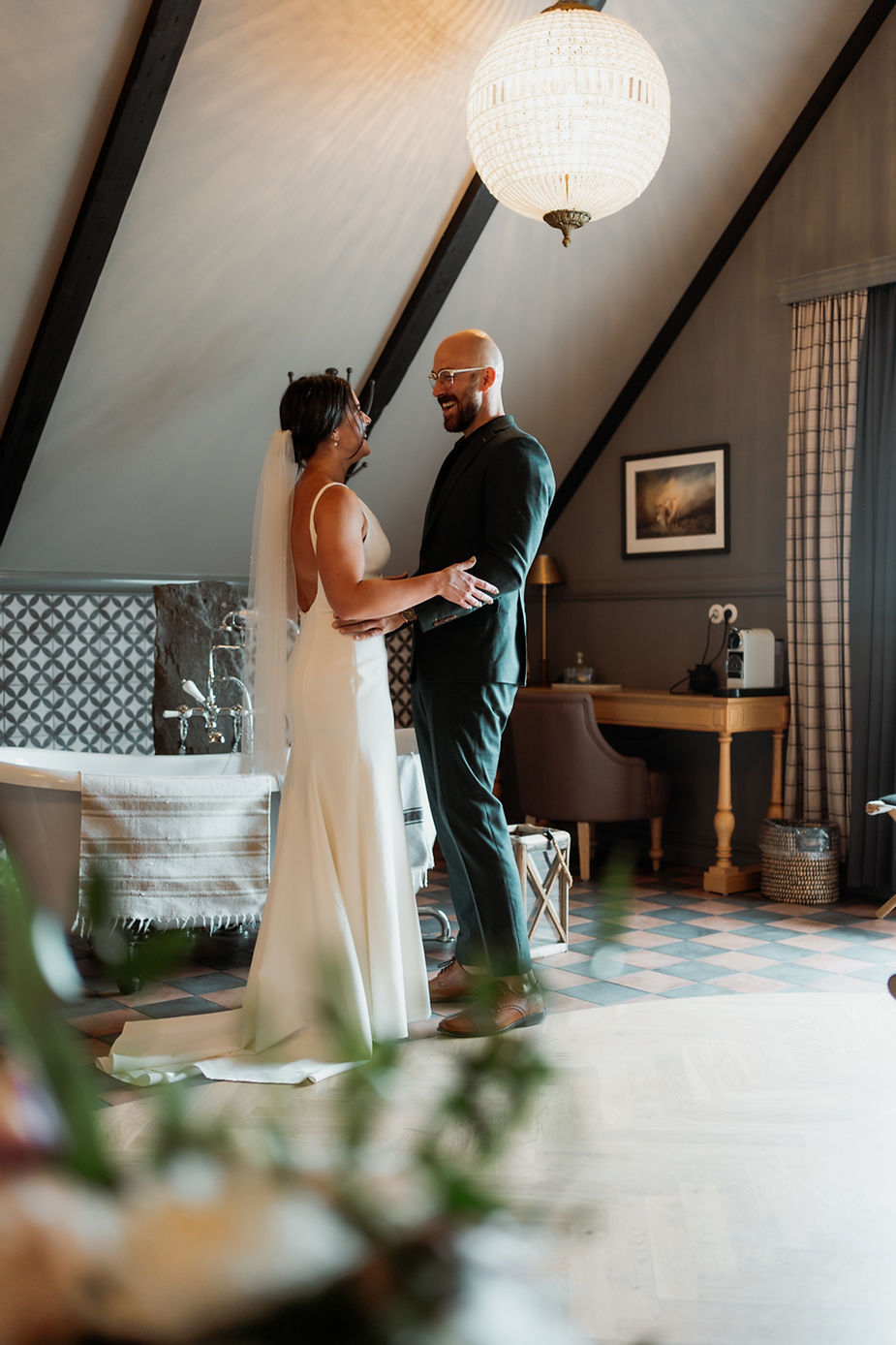 bride and groom smile and embrace during first look for iceland wedding day.