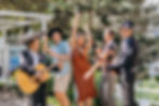 Some people getting down and dancing outside with a guitar