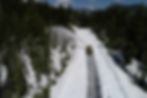 A snow plough clearing a blocked country road