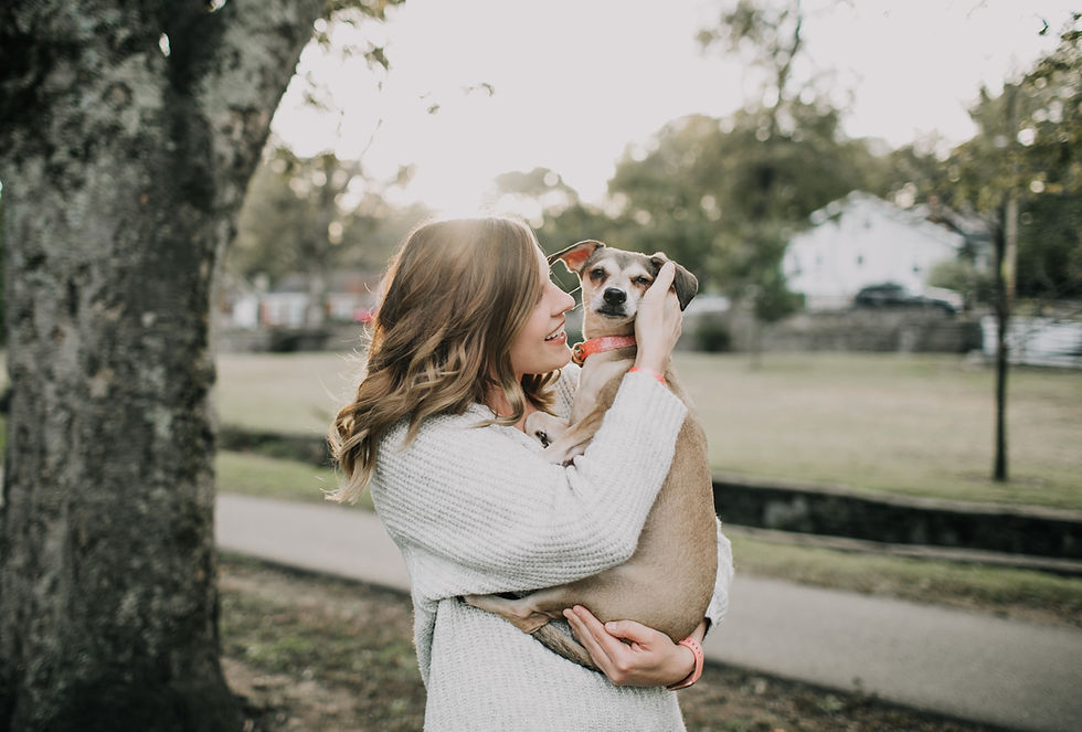 A woman carrying a dog