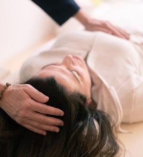 Therapist man doing Holistic therapy Reiki to a woman. Energy treatment with the heat of t