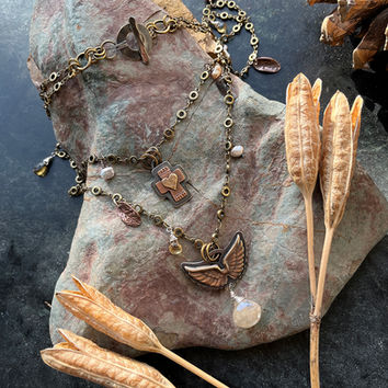 Rudilated quartz necklace with cross and wings by Linda Parks