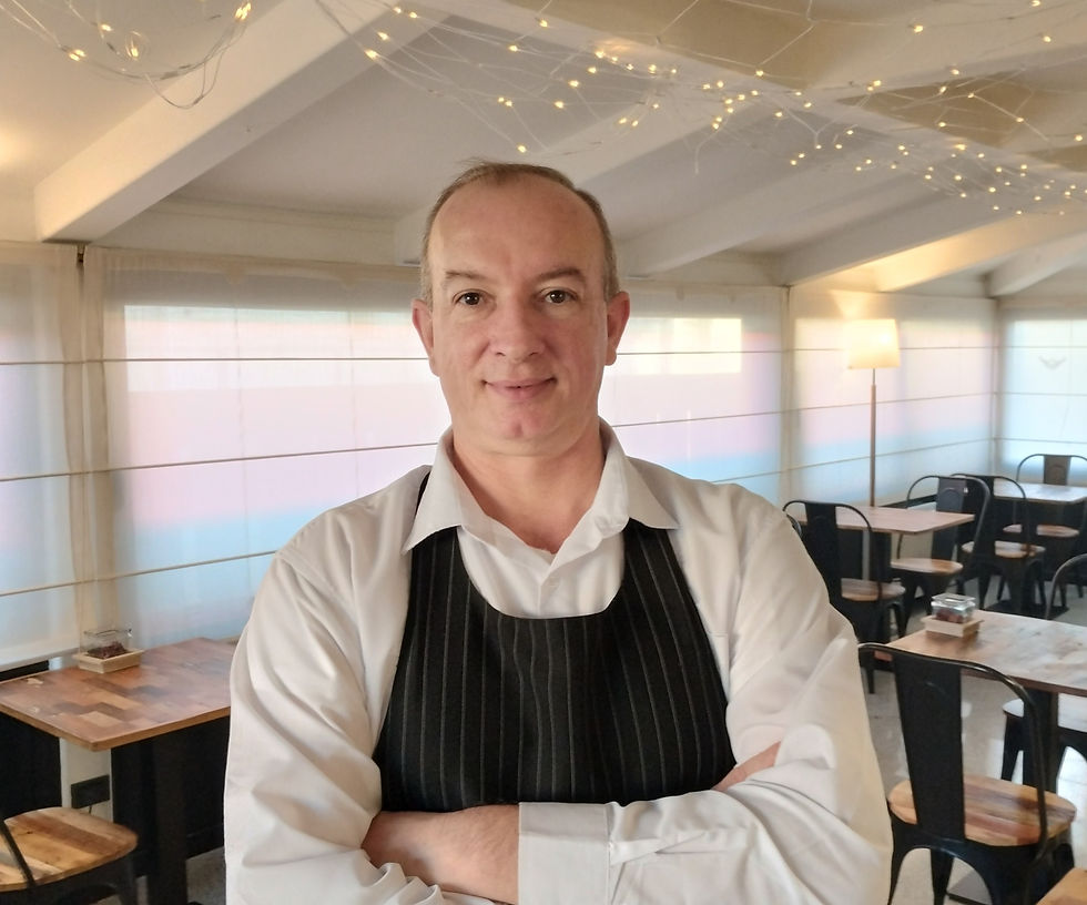man-stand up-arms-crossed-white-shirt-black-apron