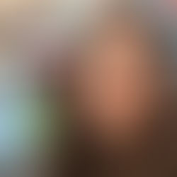 Teacher Elizabeth at a desk in a classroom in front of a computer.