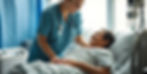 Nurse helping a patient at bedside_.jpg