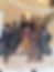 Seven stylish young men in suits and hats pose on a grand marble staircase, wearing sunglasses in an elegant mansion lobby.