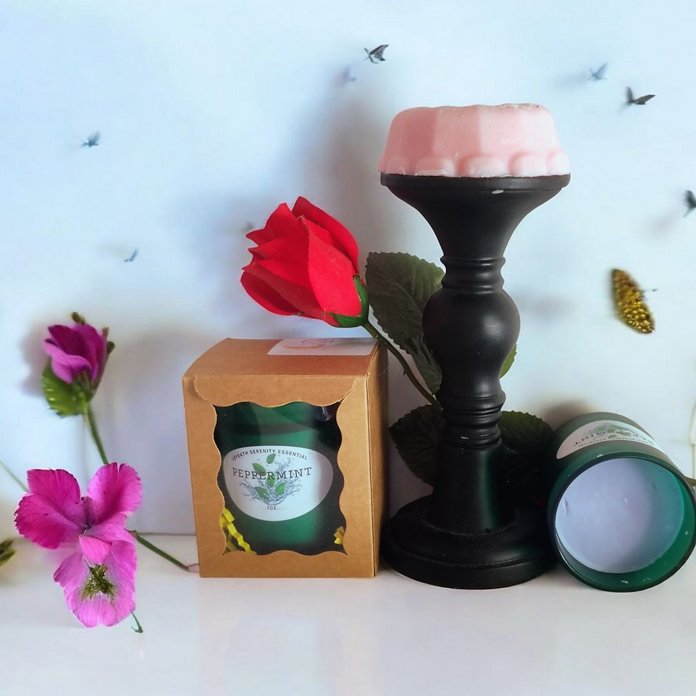 A cozy peppermint-themed display featuring a peppermint candle in a rustic brown box, complemented by pink flowers and a decorative candle holder, creating a serene and refreshing ambiance.