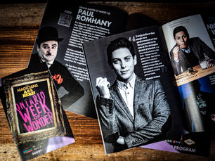 An overhead shot of the a souvenir program featuring guest artists at the OWOW Magic Festival