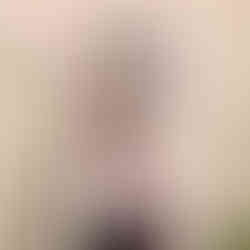 Ryan Joyce standing in front of a mirror doing up his tie