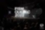 A large crowd with several thousand people and a magician on stage. The logo FISM Quebec 2022 in the foreground