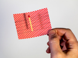 Another exposed view of the match and threads on a playing card