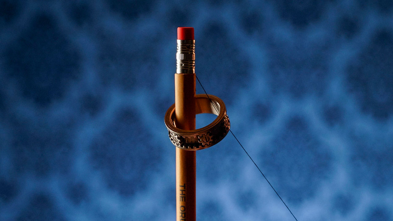Close-up exposed of the thread that secretly lifts the ring on the pencil