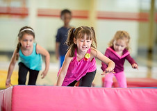 kids climbing over gym mats