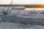 A crane operating near a warehouse undergoing tilt-up construction.