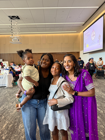 Priya posing with a woman and two girls