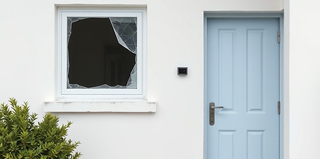 white and blue painted modern house with slightly broken glass window and door is slightly