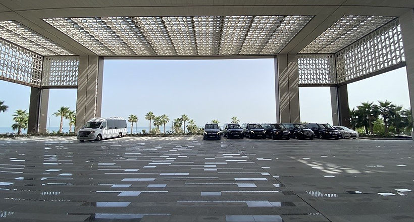 Fleet of chauffeured Mercedes vans and minibus ready for an event at a Dubai hotel
