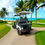 Thumbnail: KleverOmni-6 lifted 6-seat 4+2 cart with black ergonomic seats and headrests under palm trees rear view