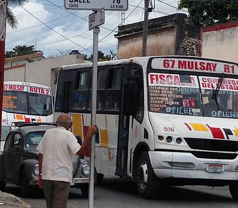 man waits for Merida city bus going down Calle 71