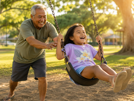Grandpa pushing granddaughter on swing